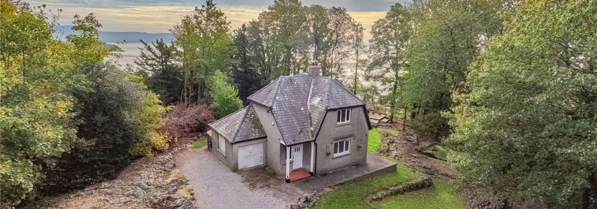 Ariel shot of a house in the middle of trees