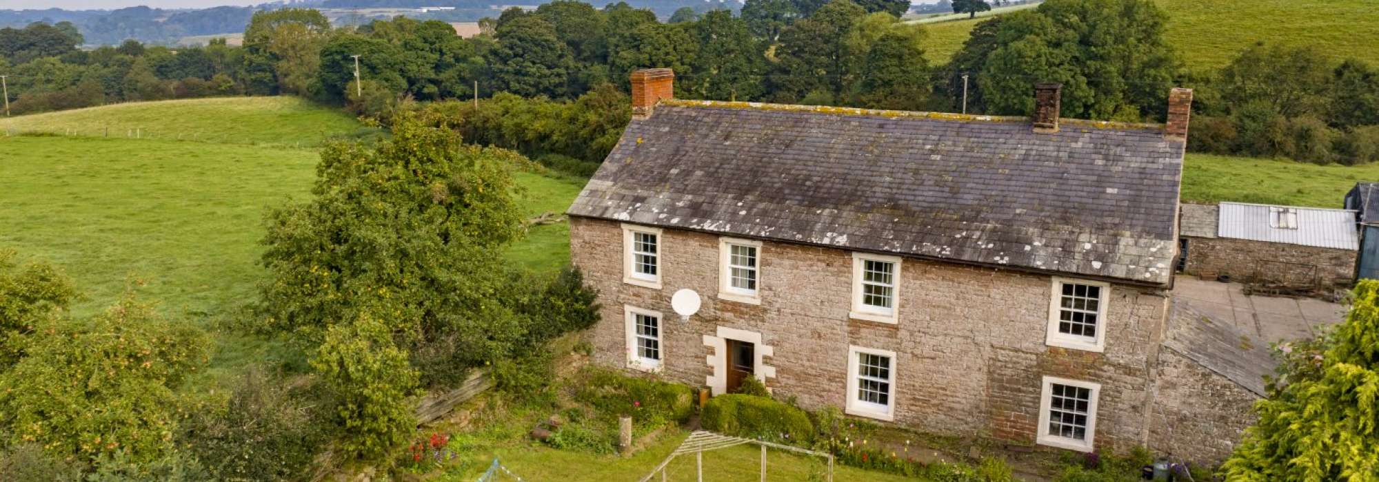Eden Banks Farm traditional stone farmhouse sat surrounded by fields and woodland 