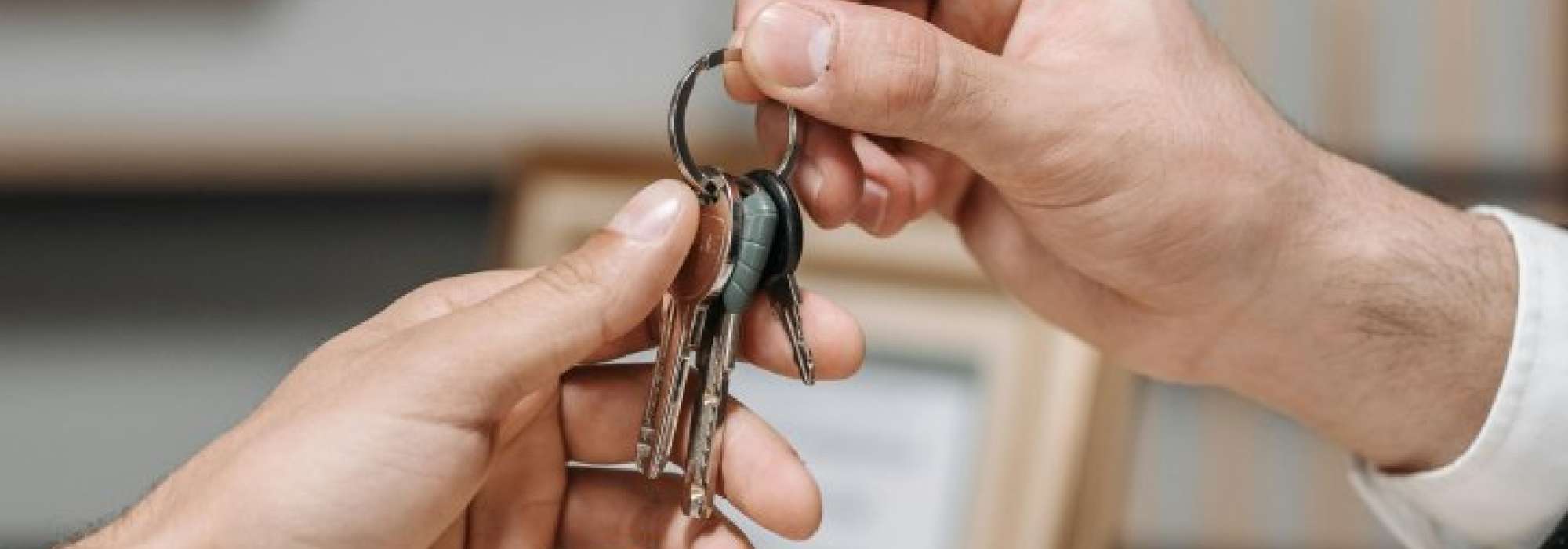 Someone handing over keys. 