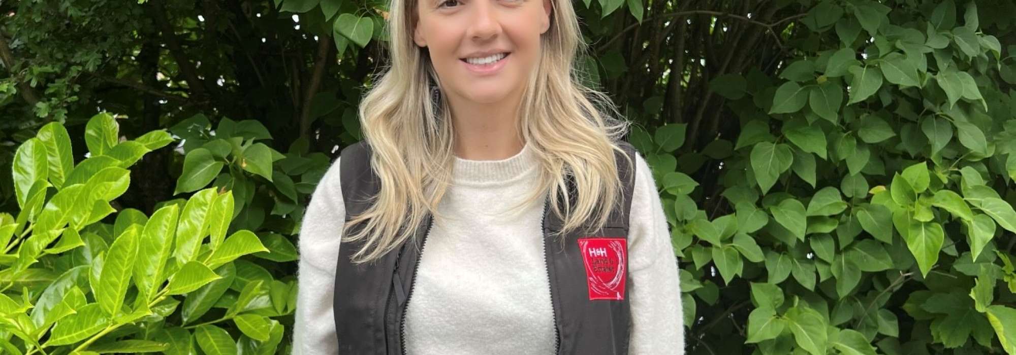 Woman standing in front of a bush