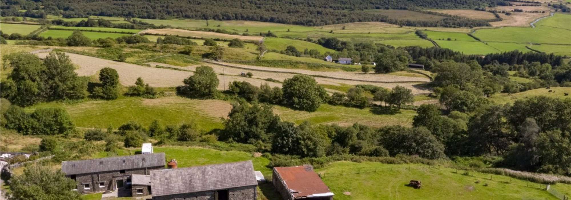 Large lot of land with a farm in the centre.